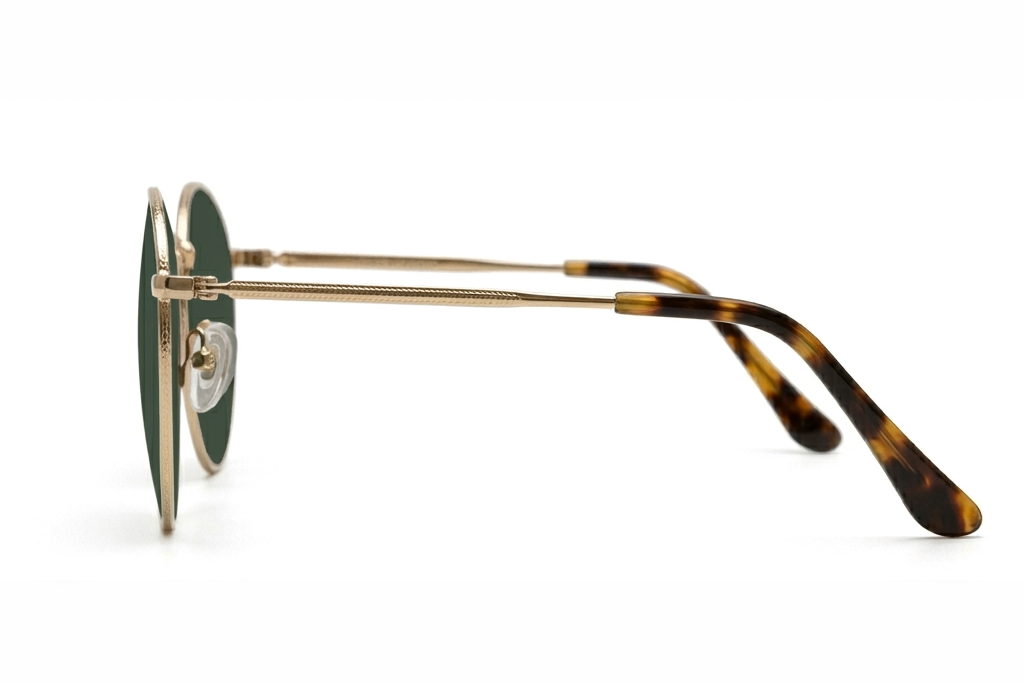 Round sunglasses with gold frame and tortoiseshell arms on a white background