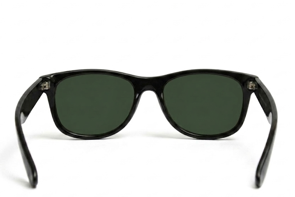 Black sunglasses with green lenses on a white background