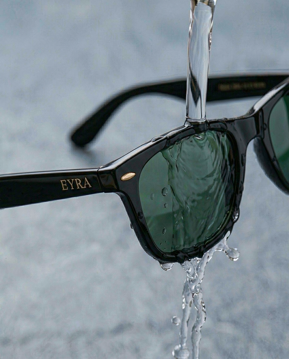 Sunglasses being rinsed under clean water to remove dust