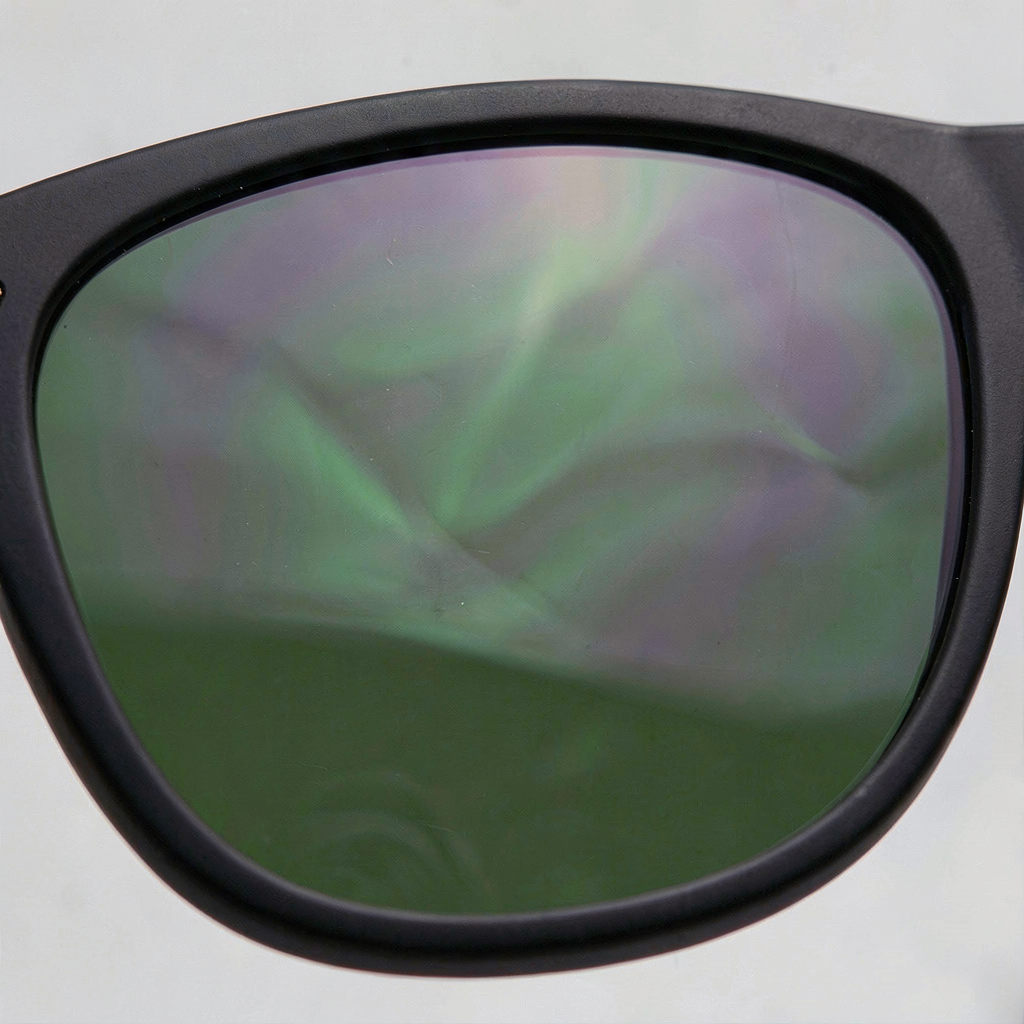 Polarized lens surface reflecting natural light, showing optical clarity
